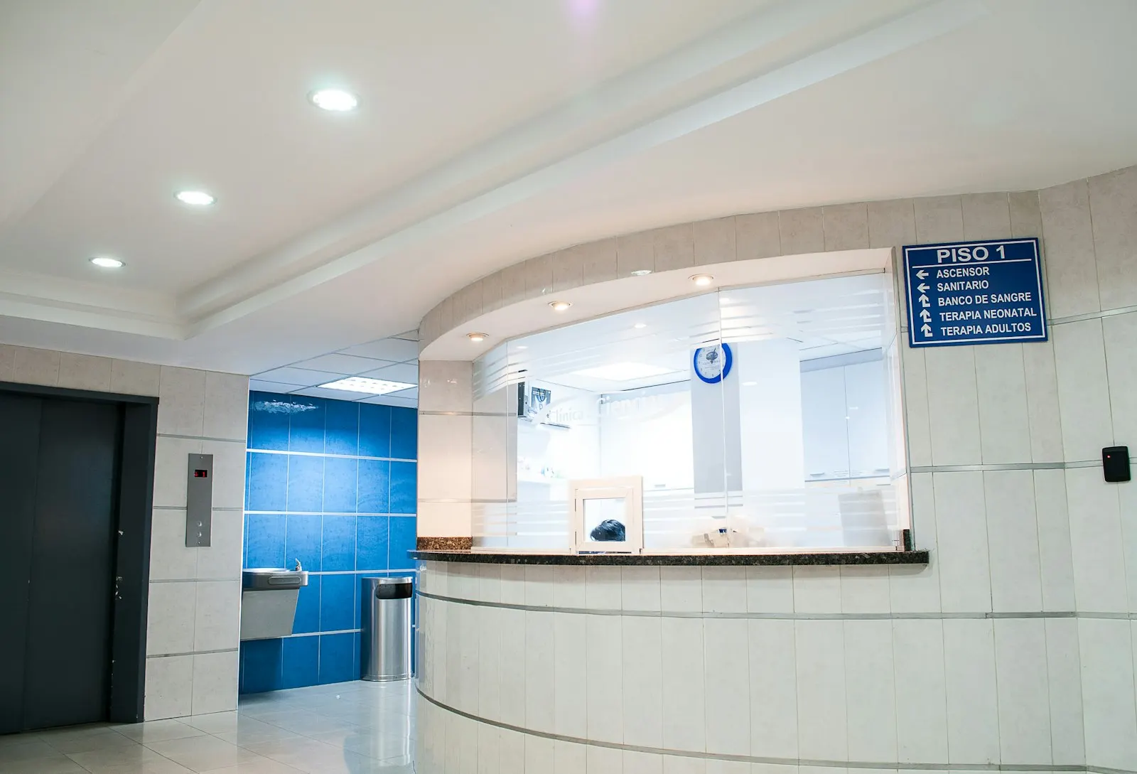 A hospital reception desk in a bright lobby